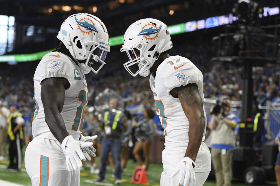Dolphins receivers Tyreek Hill (left) and Jaylen Waddle greet each other after Waddle scored on a 5-yard pass. Hill is on pace for 2,042 receiving yards this season; Waddle on pace for 1,545.