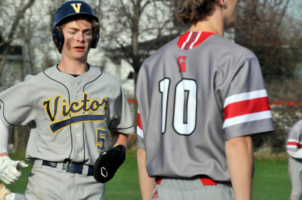 Victor's Carter Fink pulls into third base during a game against Canandaigua.