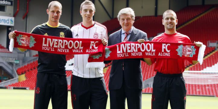 Liverpool manager Roy Hodgson poses with a trio of new signings - Joe Cole, Danny Wilson and Milan Jovanovic - during the summer 2010 window. Credit: Alamy