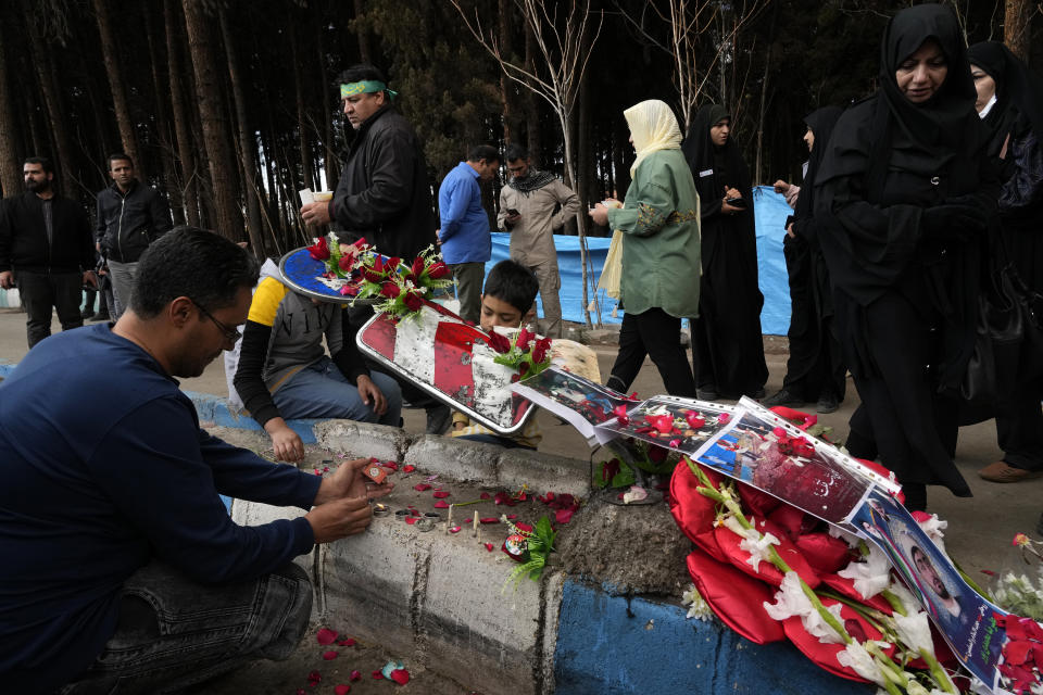 People light candles at the scene of Wednesday's bomb explosion in the city of Kerman, about 510 miles (820 kms) southeast of the capital Tehran, Iran, Thursday, Jan. 4, 2024. Investigators believe suicide bombers likely carried out an attack on a commemoration for an Iranian general slain in a 2020 U.S. drone strike, state media reported Thursday, as Iran grappled with its worst mass-casualty attack in decades and as the wider Mideast remains on edge. (AP Photo/Vahid Salemi)