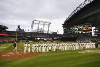 Mar 29, 2018; Seattle, WA, USA; Members of the Seattle Mariners (right) and Cleveland Indians stand during the national anthem before the season opener at Safeco Field. Mandatory Credit: Joe Nicholson-USA TODAY Sports