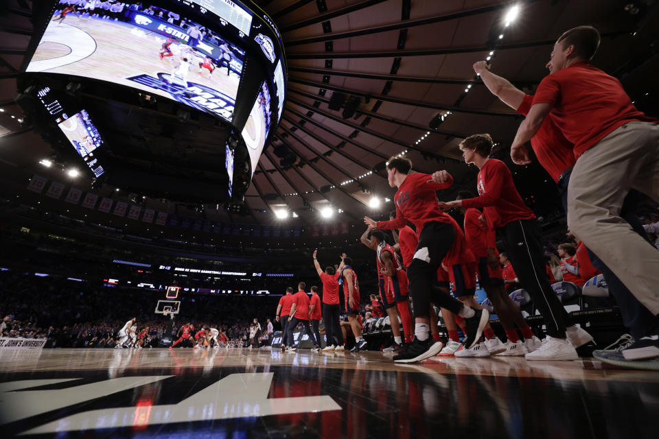 Florida Atlantic players celebrate after defeating Kansas State 79-76 in an Elite 8 college basketball game in the NCAA Tournament's East Region final, Saturday, March 25, 2023, in New York. (AP Photo/Adam Hunger)