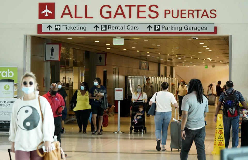 People make their way through Love Field airport Friday, May 28, 2021, in Dallas. (AP Photo/LM Otero)