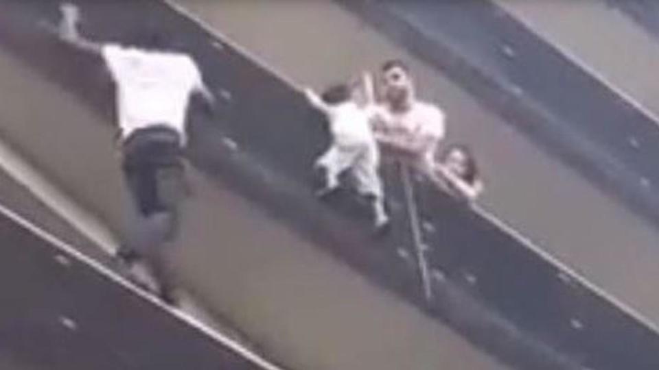 The 22-year-old man didn't hesitate when he saw the toddler hanging from the balcony.