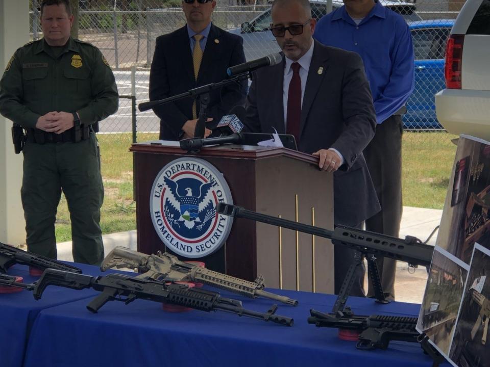 Homeland Security Investigations officials display high-powered rifles seized en route to Mexican cartels during a recent news conference in Laredo, Texas -- a smuggling hot spot.