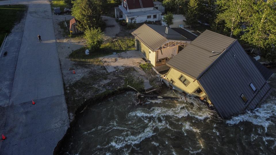 FILE - A house sits in Rock Creek after floodwaters washed away a road and a bridge in Red Lodge, Mont., June 15, 2022. Looking back at 2022’s weather with months of analysis, the World Meteorological Organization says last year really was as bad as it seemed. (AP Photo/David Goldman, File)