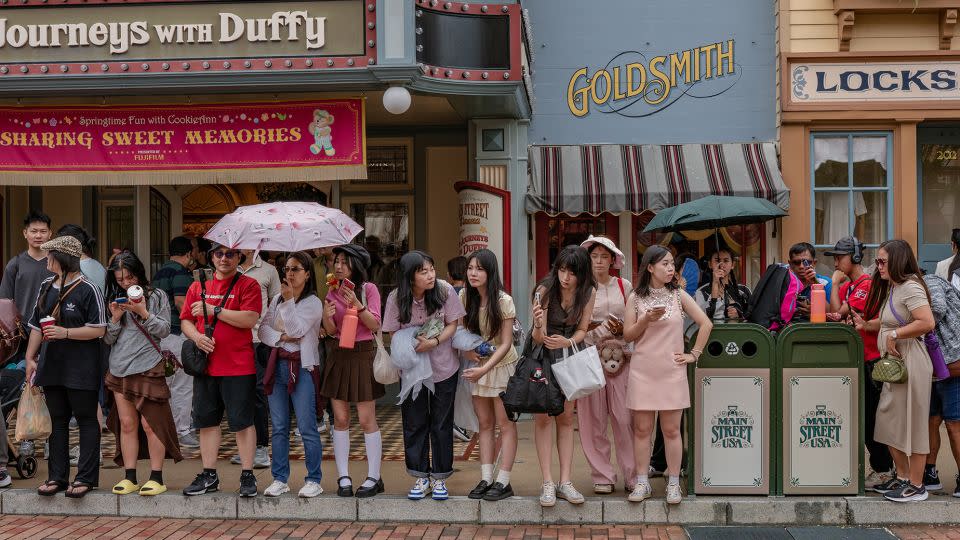 A crowd gathers to watch a parade on Main Street USA. - Noemi Cassanelli/CNN