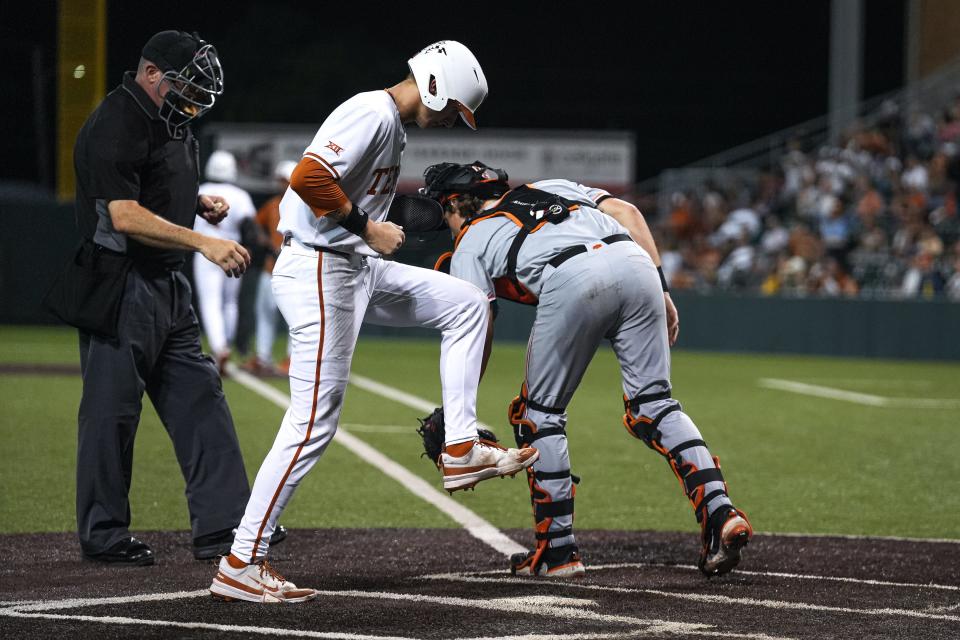 Texas' Jared Thomas stomps on first base during Friday's 7-5 win over Oklahoma State. The Horns are in a three-way tie for second place behind Oklahoma in the Big 12 standings with two conference series remaining.