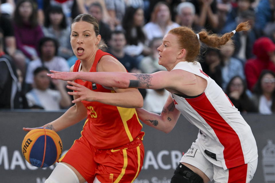 Sandra Ygueravide, left, of Spain, is challenged by Kacie Bosch, right, of Canada, for the ball during the FIBA 3x3 basketball Olympic qualifying tournament women's semifinal match in Debrecen, Hungary, Sunday, May 19, 2024. (Zsolt Czegledi/MTI via AP)