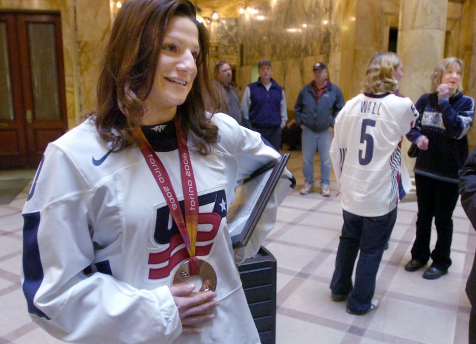 Kim Insalaco, front, and Lyndsay Wall, back, with their Olympic hockey Bronze Medals after a ceremony at the County Office Building atrium.