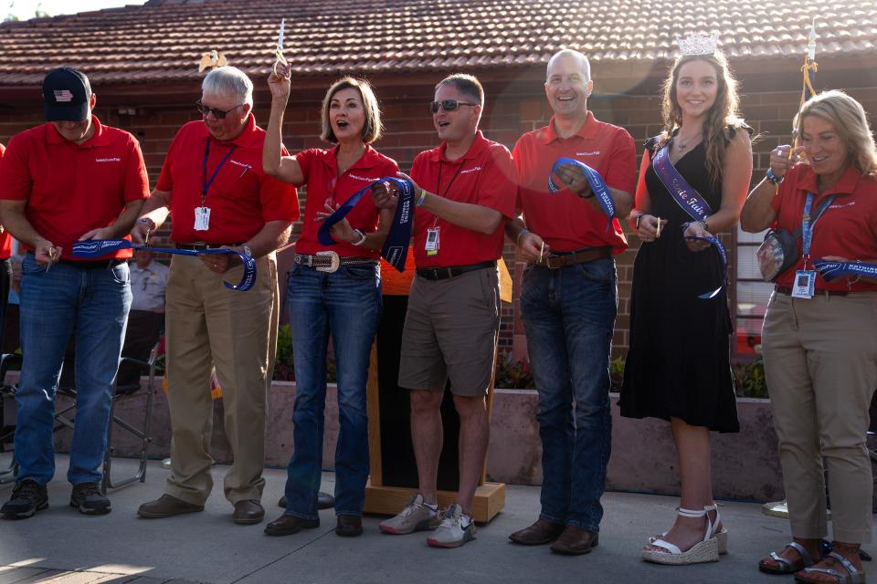 Gov. Kim Reynolds, Iowa State Fair CEO Jeremy Parsons and others cut the ribbon on the updated Public Safety Building at the Iowa State Fair during the fair's opening ceremonies, on Thursday, Aug. 10, 2023, in Des Moines.