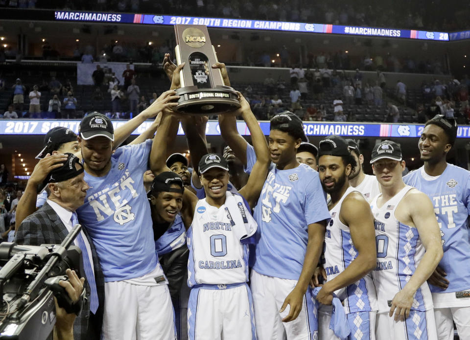 North Carolina players and coaches celebrate after beating Kentucky 75-73 in the South Regional final game in the NCAA college basketball tournament Sunday, March 26, 2017, in Memphis, Tenn. (AP Photo/Mark Humphrey)