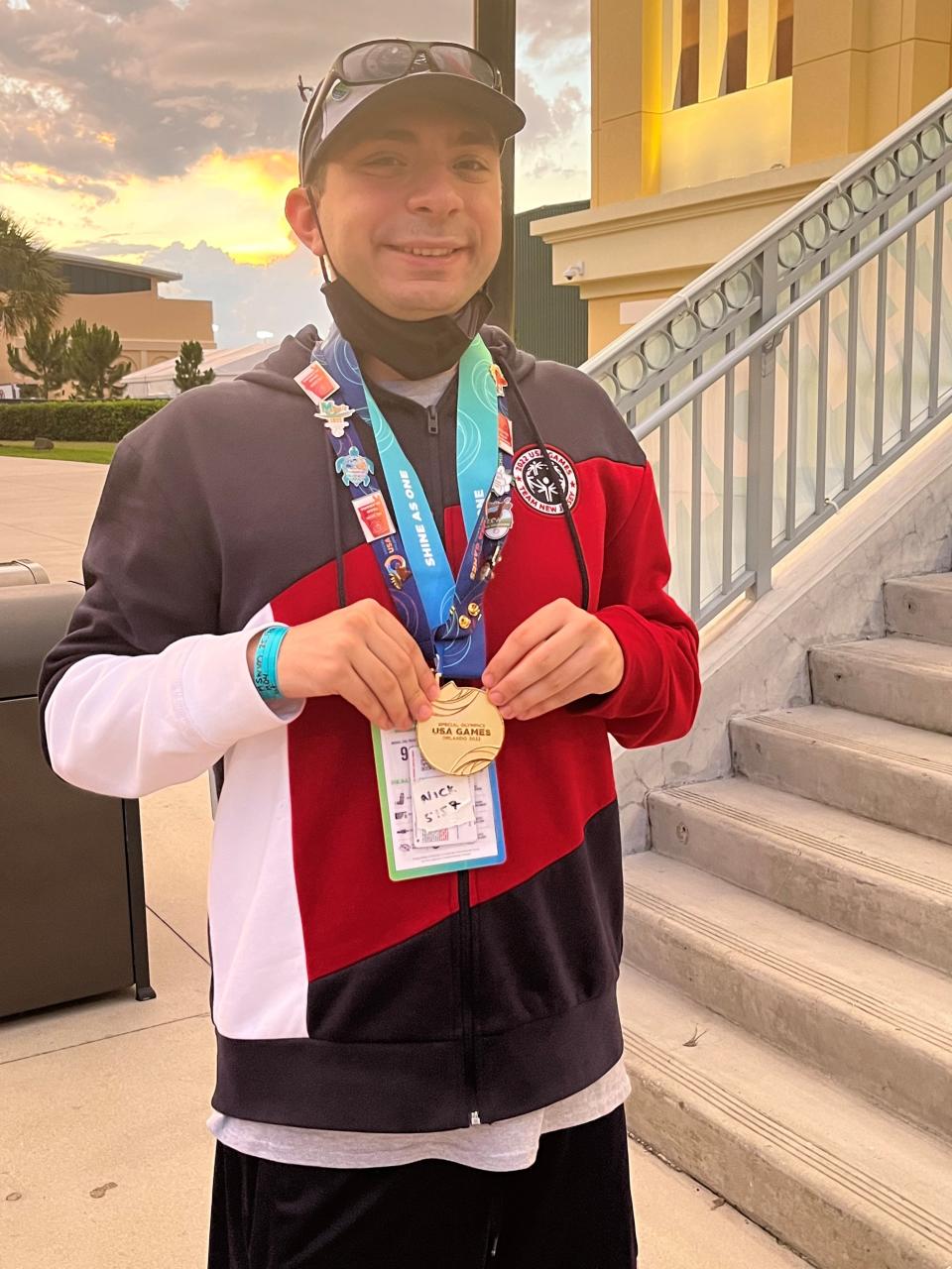 Nicholas Zellin with his gold medal for the 25-yard freestyle at the Special Olympics USA Games on Tuesday, June 7, 2022 in Orlando, Florida.