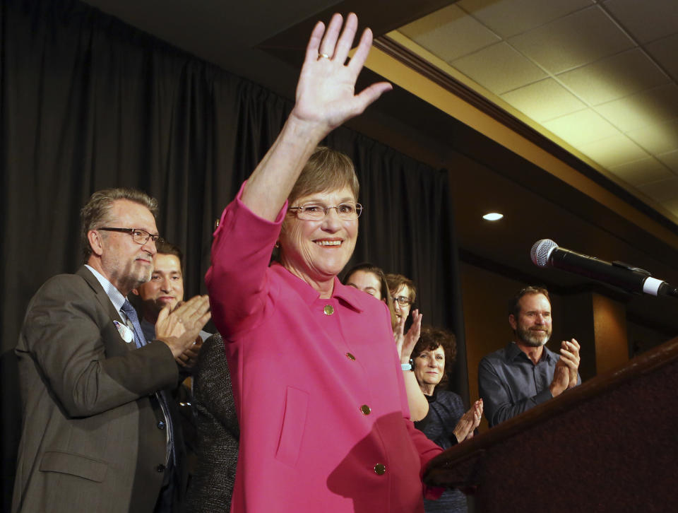 Democrat Laura Kelly waved to the crowd at the Ramada Hotel and Convention Center in Topeka after she won election Tuesday, Nov. 6, 2018, to become the next Kansas governor. On the left is her running mate Lynn Rogers. (Thad Allton /The Topeka Capital-Journal via AP)