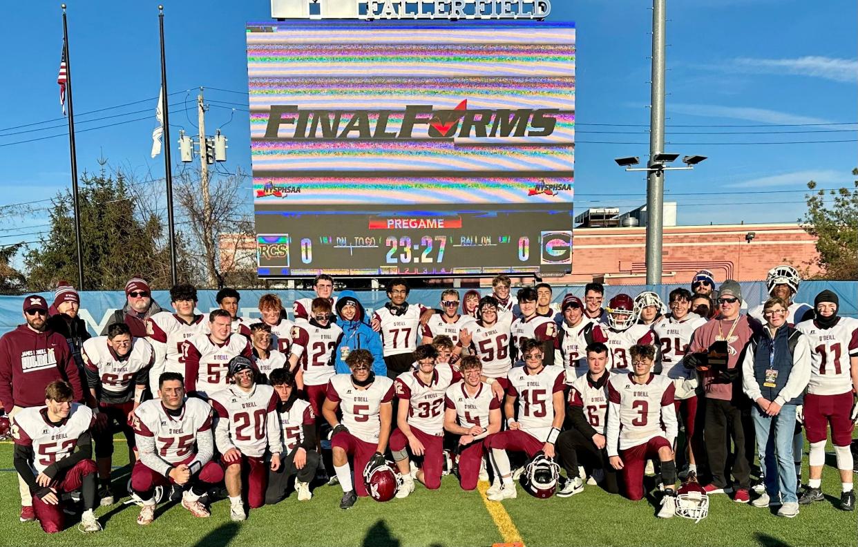 The James I. O'Neill football team poses on the Middletown High School field after falling to Fonda-Fultonville in a Class C state semifinal on Nov. 25, 2023.