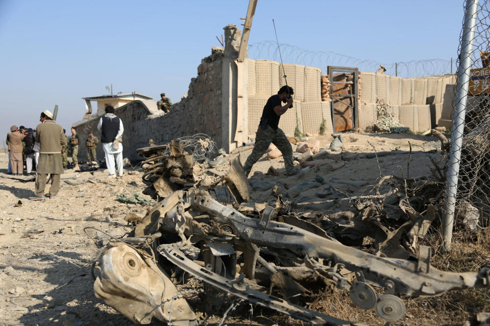 Afghan officials investigate the site of a deadly suicide attack on a joint NATO-Afghan base in the Ghani Khail district of Nangarhar province, east of Jalalabad, Afghanistan, Saturday, Jan. 4, 2014. NATO said a service member had died following a suicide bombing in eastern Afghanistan, without identifying the soldier's nationality. Afghan insurgents have intensified attacks recently in a campaign to regain territory as foreign forces prepare to leave at the end of 2014. (AP Photo/Rahmat Gul)