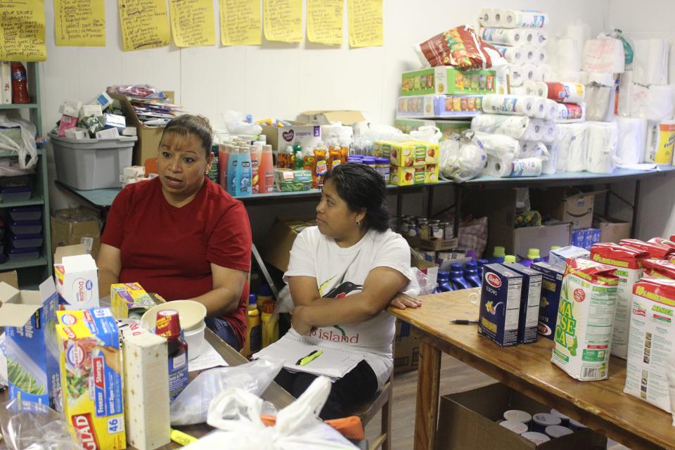 Yolanda Soto, left, and Dorcas Diego help coordinate donations for families affected by immigration raids Aug. 7.