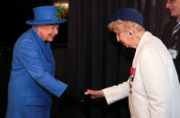Britain's Queen Elizabeth shakes hands with Bletchley Park veteran Ruth Bourne during her visit at the Watergate House to mark the centenary of the GCHQ (Government Communications Head Quarters) in London, Britain, February 14, 2019. REUTERS/Hannah McKay/Pool