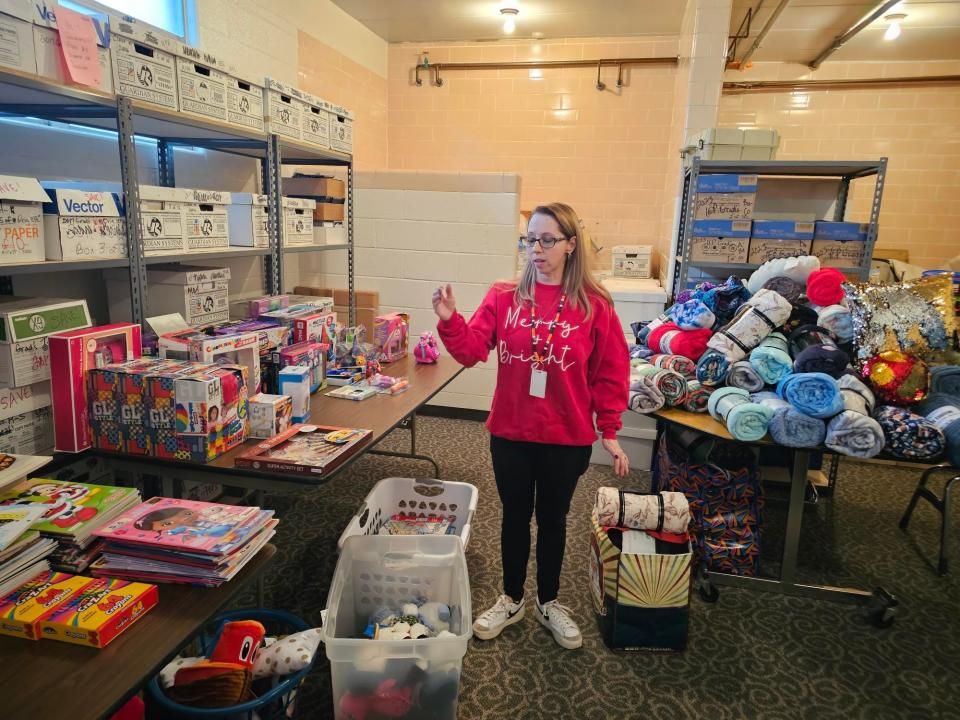 Erica Thom, executive director of AHEAD Inc. and organizer of the Amanda's Hope Food Drive, stands among the hundreds of toys and blankets purchased for about 150 kids.