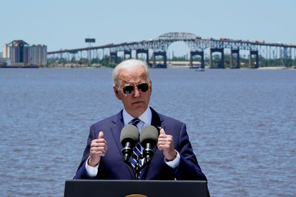 President Joe Biden speaks with the Interstate 10 Calcasieu River Bridge behind him, Thursday, May 6, 2021, in Lake Charles, La. 