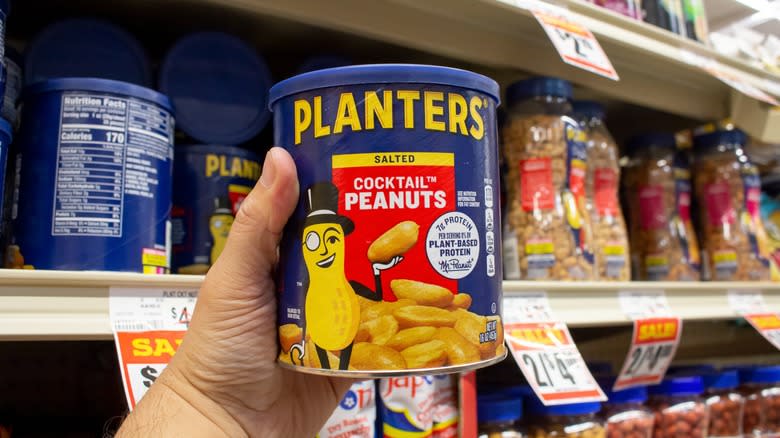 hands holding planters peanuts