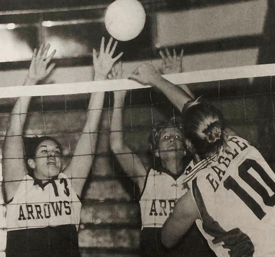 Watertown's Molly Merrigan (left) and Joanne Heiden defend against Aberdeen Central's Holly Retzer during a high school volleyball match the 2000 Watertown Invitational.