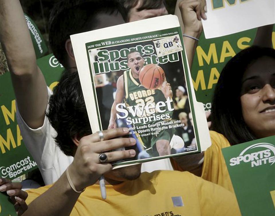 A George Mason University fan holds up the cover of Sports Illustrated magazine at a sendoff for the team.