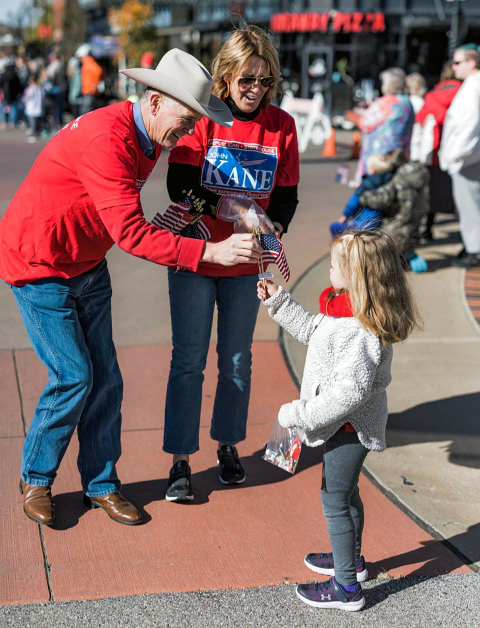 Newly elected State Rep. John Kane, R-Bartlesville, passes out flags during a 2022 campaign stop.