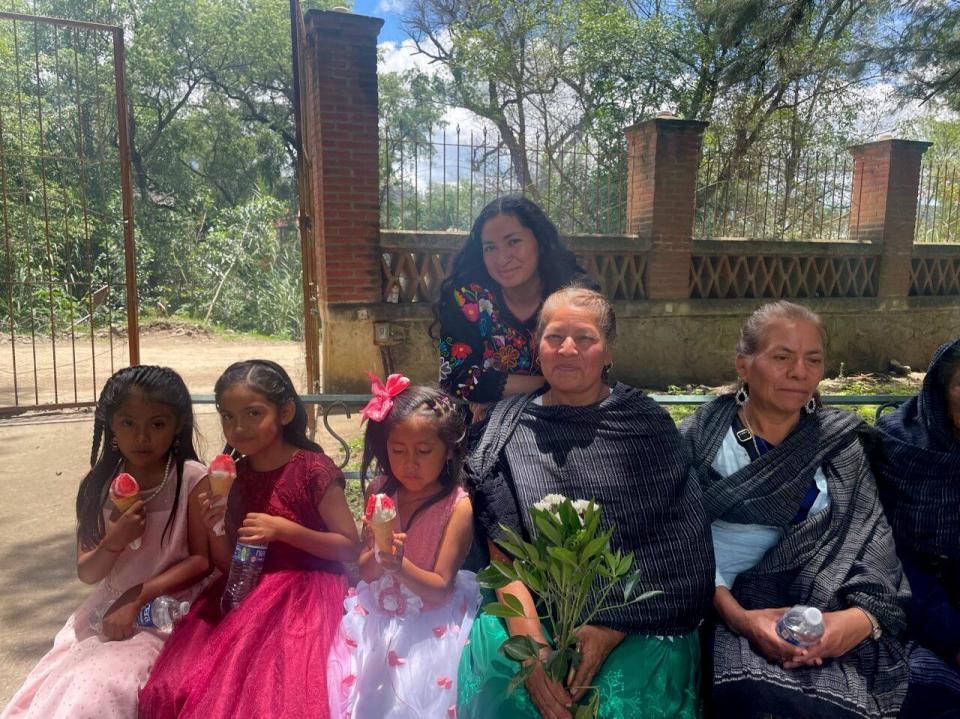 Eva Gomez waits for the start of a procession to a church in San Juan Mixtepec