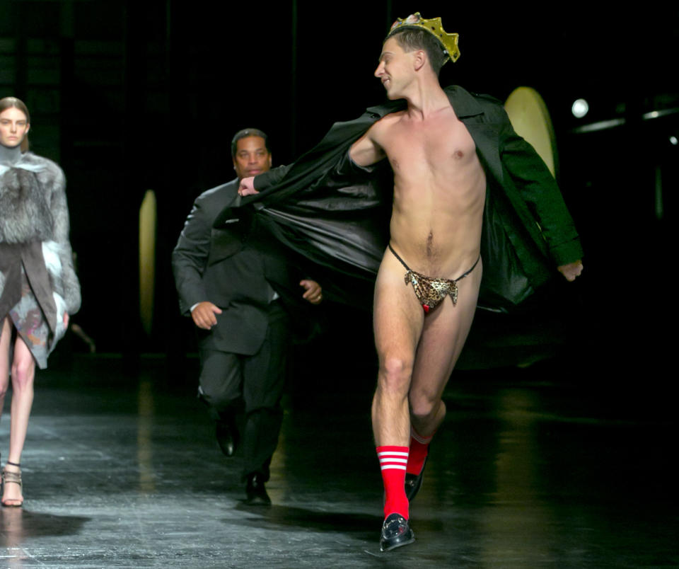 A streaker in a G-string, who interrupted the Prabal Gurung Fall 2014 collection as it is modeled, is chased by security, during Fashion Week, in New York, Saturday, Feb. 8, 2014. (AP Photo/Richard Drew)