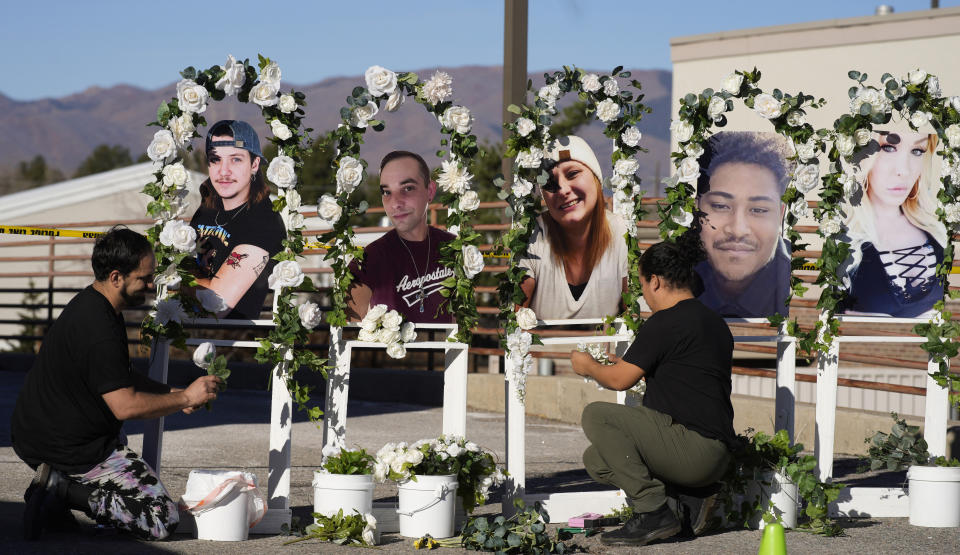 FILE - Noah Reich, left, and David Maldonado, the Los Angeles co-founders of Classroom of Compassion, put up a memorial Nov. 22, 2022, with photographs of the five victims of a weekend mass shooting at a nearby gay nightclub in Colorado Springs, Colo. Colorado’s governor signed four gun control bills Friday, April 28, 2023, edging the once-purple state closer to liberal-leaning governments in California and New York just months after a shooting at an LGBTQ nightclub in Colorado Springs, the latest in the state’s long history of notorious massacres. (AP Photo/David Zalubowski, File)