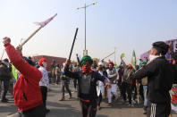 DELHI, INDIA - 2021/01/26: Protesters march through the Streets while chanting slogans during the demonstration. Farmers protesting against agricultural reforms breached barricades and clashed with police in the capital on the India's 72nd Republic Day. The police fired tear gas to restrain them, shortly after a convoy of tractors trundled through the Delhi's outskirts. (Photo by Amarjeet Kumar Singh/SOPA Images/LightRocket via Getty Images)