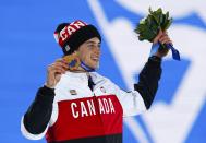 Bronze medalist Mark McMorris of Canada celebrates during the medal ceremony for the men's snowboard slopestyle competition in the Olympic Plaza at the 2014 Sochi Olympic Games February 8, 2014. REUTERS/Shamil Zhumatov (RUSSIA - Tags: OLYMPICS SPORT SNOWBOARDING)