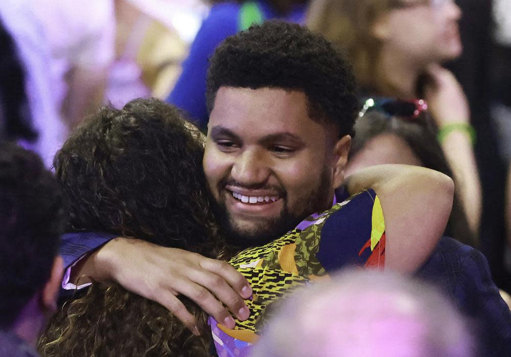 Maxwell Frost greets supporters who have gathered at the Renaissance Theatre Company in Orlando, Fla., on election night, Tuesday, Aug. 23, 2022. (Stephen M. Dowell/Orlando Sentinel via AP)