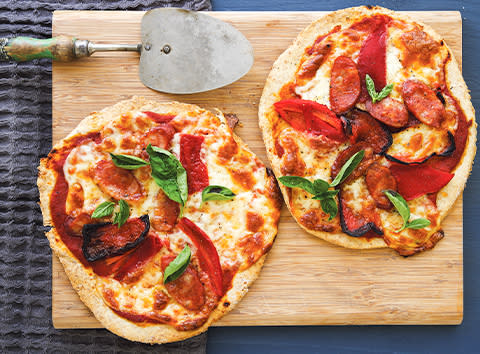 <b>Ingredients</b> 2 prepared wholemeal pizza bases (see recipe, slide 6) 6 tbs (90g) prepared tomato and red capsicum puree (see recipe, slide 6) 200g reduced-fat mozzarella, sliced 2 red capsicums, seeded and quartered 2 x 50g chorizo sausages, sliced on the diagonal Handful of fresh basil leaves, torn <b>Method</b> Preheat oven to 220°C. Spread each pizza base with three tablespoons of the tomato and red capsicum puree. Top with cheese, capsicum and chorizo. Bake for 15 to 20 minutes until golden. Season to taste and serve topped with basil. Makes 2. <i> Per pizza: 2528kJ, 39g fat (15g sat), 18g carbs, 2g fibre, 42g protein, 1617mg sodium</i>