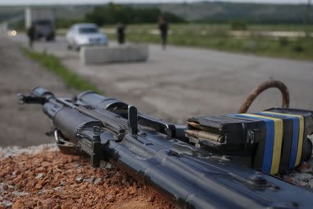 A weapon and magazines loaded with bullets are pictured at a position where Ukrainian soldiers are standing guard near the eastern Ukrainian city of Konstantinovka July 10, 2014. REUTERS/Gleb Garanich