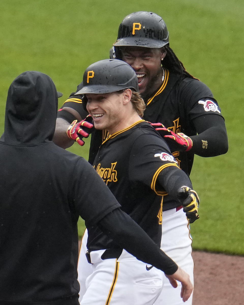 Pittsburgh Pirates' Jack Suwinski, center, celebrates with Oneil Cruz, rear, after driving in the winning run with a walkoff single off Colorado Rockies relief pitcher Nick Mears during the ninth inning of a baseball game in Pittsburgh, Saturday, May 4, 2024. (AP Photo/Gene J. Puskar)