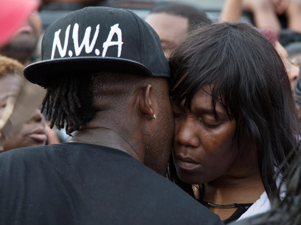 Sandra Sterling, is comforted during a community vigil in memory of her nephew, Alton Sterling.