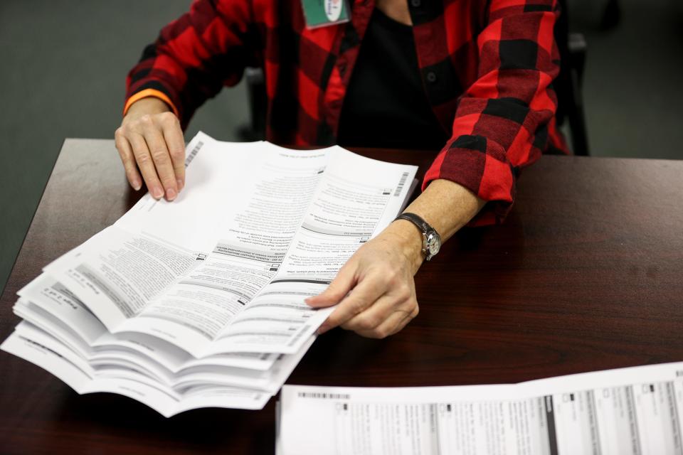 Workers open and sort ballots at the Marion County Election office on Nov. 3.