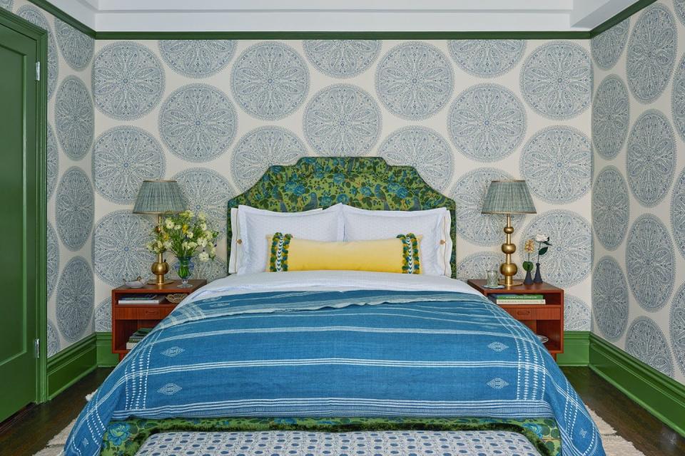 a bed with a blue and yellow comforter