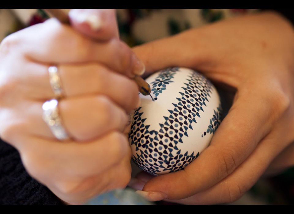 HOYERSWERDA, GERMANY - MARCH 24:  Melanie Baier from the village Obergurig wearing a traditional Lusatian sorbian folk dress, paints an Easter egg in traditional Sorbian motives at the annual Easter egg market on March 24, 2012 in Schleife, near Hoyerswerda, Germany. Easter egg painting is a strong part of Sorbian tradition and visual elements within the painting are meant to ward off evil. Sorbians are a Slavic minority in eastern Germany and many still speak Sorbian, a language closely related to Polish and Czech.  (Photo by Carsten Koall/Getty Images)