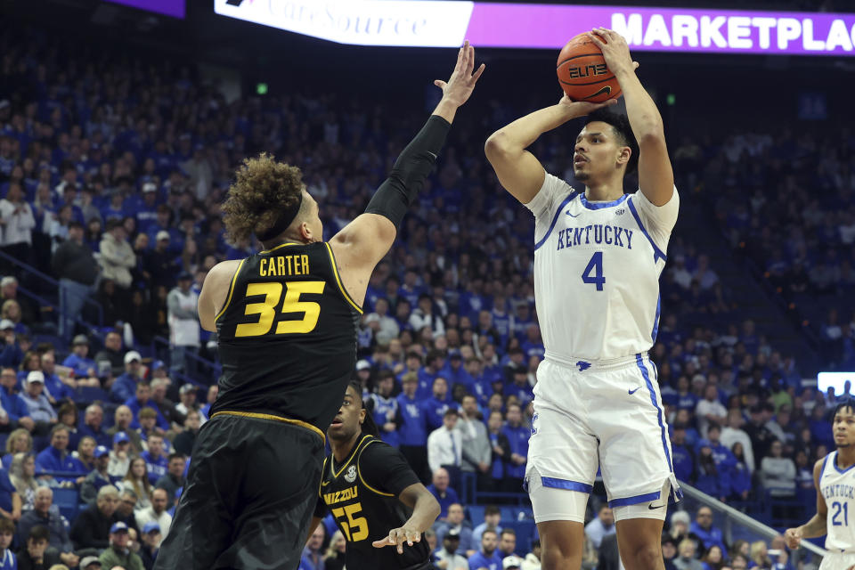 Kentucky's Tre Mitchell (4) shoots while defended by Missouri's Noah Carter (35) during the first half of an NCAA college basketball game in Lexington, Ky., Tuesday, Jan. 9, 2024. (AP Photo/James Crisp)