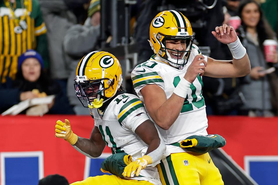 Green Bay Packers wide receiver Jayden Reed (11) celebrates scoring a touchdown with Jordan Love after the game during an NFL football game Monday, Dec. 11, 2023, in East Rutherford, N.J.