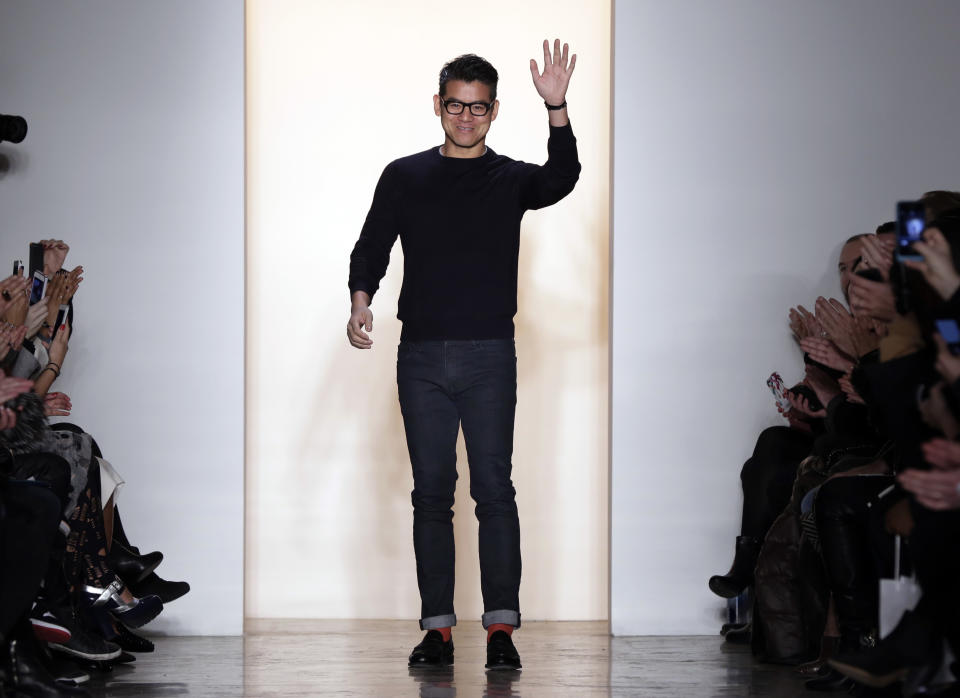 Designer Peter Som acknowledges audience applause after his Fall 2014 collection was modeled during Fashion Week in New York, Friday, Feb. 7, 2014. (AP Photo/Richard Drew)