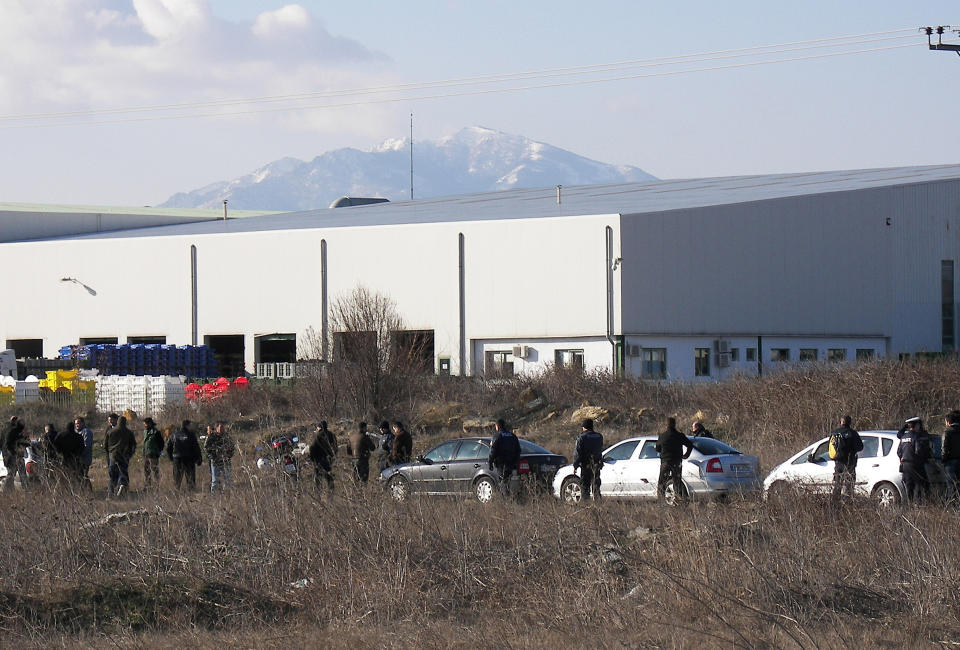 Police secure the area around a factory in the northern city of Komotini, about 800 kilometers (500 miles) northeast of Athens, Thursday, March 1, 2012. An unemployed man shot and wounded two people and took two others hostage at the plastics factory. The shooter, who was fired from the factory eight months ago, burst into the site with a with a shotgun, wounding a member of the management and another employee, police said. (AP Photo/Paratiritis Thrakis, Thomas Stamoulis)