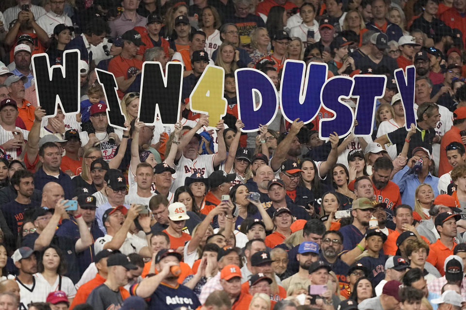 Fans hold up a sign for Houston Astros manager Dusty Baker Jr. during the first inning in Game 6 of baseball's World Series between the Houston Astros and the Philadelphia Phillies on Saturday, Nov. 5, 2022, in Houston. (AP Photo/David J. Phillip)
