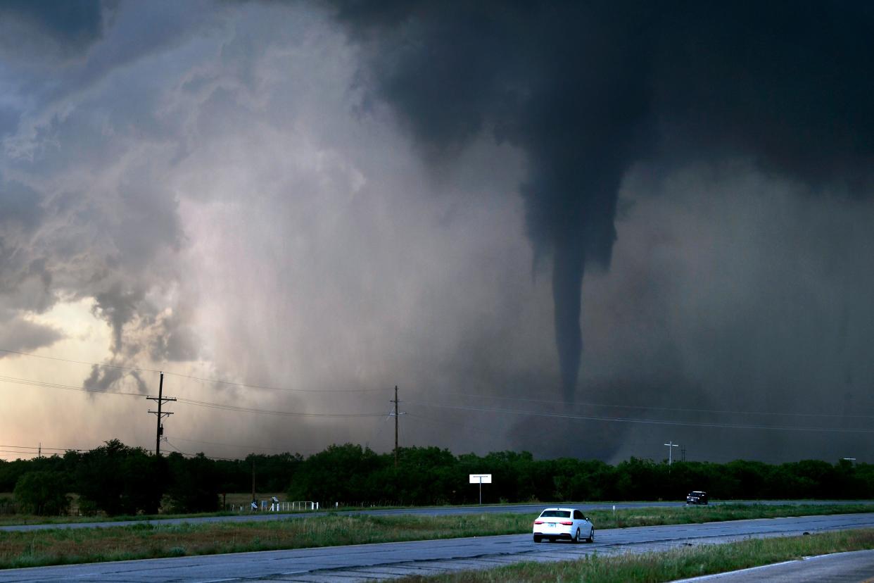 A tornado spins west of Hawley, Texas as cars pass on U.S. 277 on May 2, 2024. Damage was reported in Hawley, with hail reported up to baseball size.