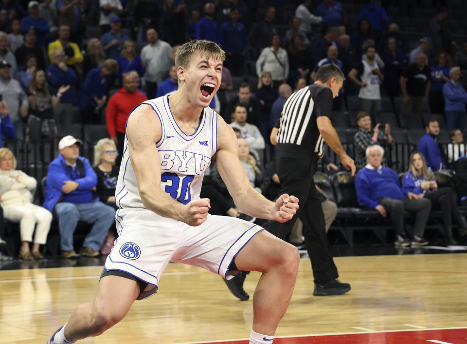 BYU guard Dallin Hall (30) reacts to his team's win at the end of an NCAA college basketball game against Creighton Saturday, Dec. 10, 2022, in Las Vegas. BYU won 83 to 80. (AP Photo/Ronda Churchill)