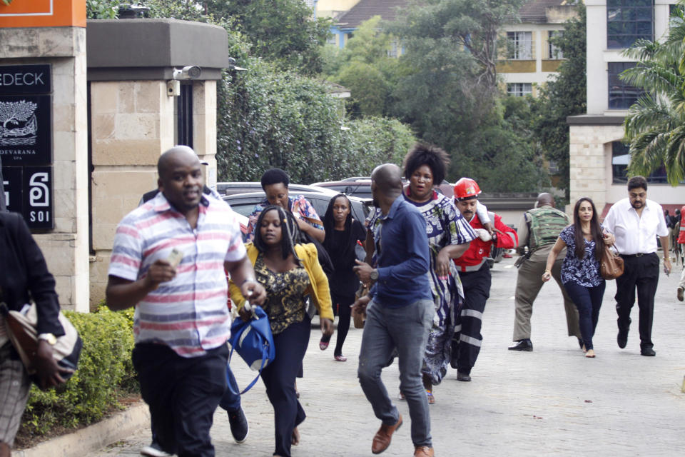 Security forces help civilians at the scene of a blast in Nairobi, Kenya, Tuesday, Jan. 15, 2019. Terrorists attacked an upscale hotel complex in Kenya’s capital Tuesday, sending people fleeing in panic as explosions and heavy gunfire reverberated through the neighborhood. (AP Photo/Khalil Senosi)