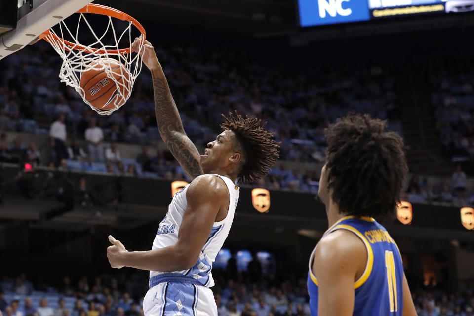 North Carolina forward Armando Bacot (5) dunks while Pittsburgh guard Justin Champagnie (11) looks on during the first half of an NCAA college basketball game in Chapel Hill, N.C., Wednesday, Jan. 8, 2020. (AP Photo/Gerry Broome)